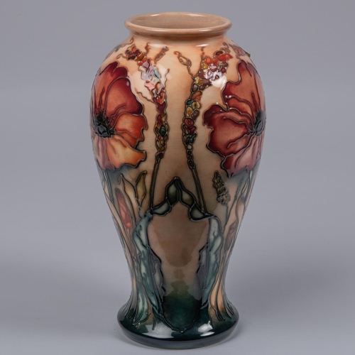 59 - A Moorcroft pottery vase. Stylised poppies on a graded green and peach ground. Marks to base, diamon... 