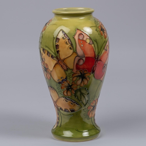 6 - A Moorcroft pottery vase from 1994. A trial piece with butterfly designs. Marks etc to base with eye... 