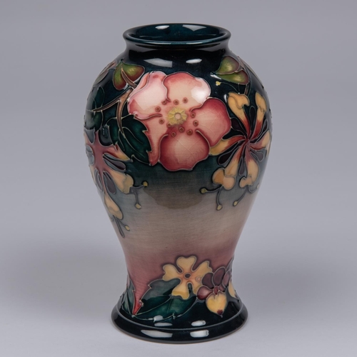 63 - A Moorcroft pottery vase. Trial vase flowers on a graded ground. Marks to base, MP, diamond date cyp... 