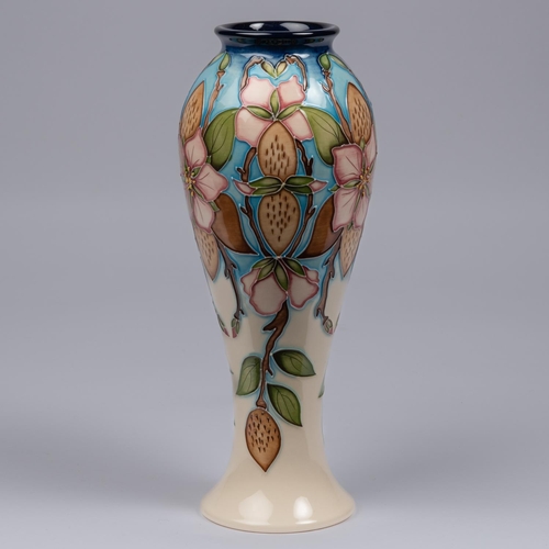 64 - A Moorcroft pottery vase. Pale straberries on a cream and blue ground. Marks to base, pineapple date... 