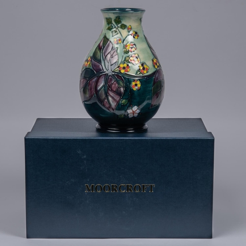 67 - A Moorcroft pottery vase. Brambles with multi-colour berries and purple leaves. Marks to base, bell ... 