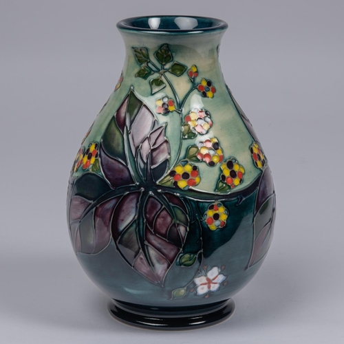 67 - A Moorcroft pottery vase. Brambles with multi-colour berries and purple leaves. Marks to base, bell ... 