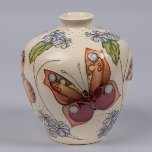 7 - A Moorcroft pottery vase. With butterfly designs. Marks etc to base. H.170mm GC, some crazing to gla... 