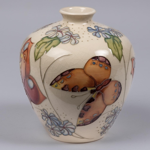 7 - A Moorcroft pottery vase. With butterfly designs. Marks etc to base. H.170mm GC, some crazing to gla... 