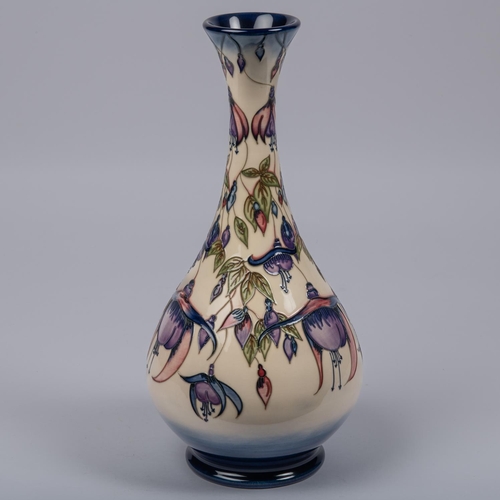 8 - A Moorcroft pottery vase from 2001. With fuchsia design in purple. Impressed marks etc to base with ... 