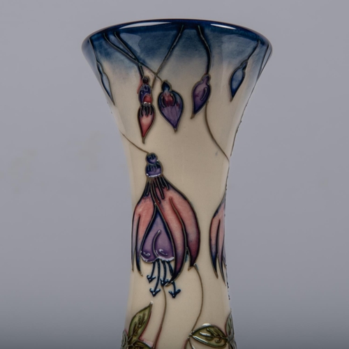 8 - A Moorcroft pottery vase from 2001. With fuchsia design in purple. Impressed marks etc to base with ... 