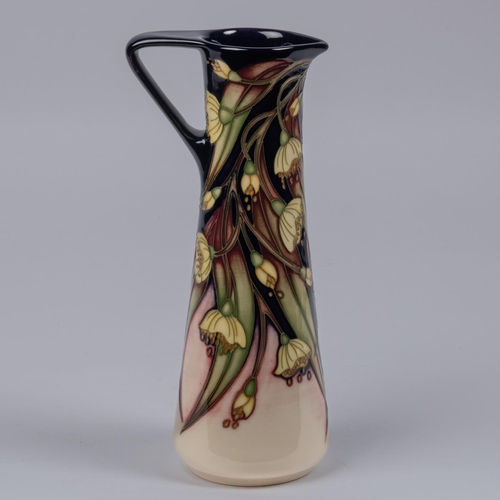 9 - A Moorcroft pottery jug from 2005. With floral design. Marks etc to base with HM and M.C.C. for Moor... 