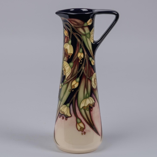 9 - A Moorcroft pottery jug from 2005. With floral design. Marks etc to base with HM and M.C.C. for Moor... 