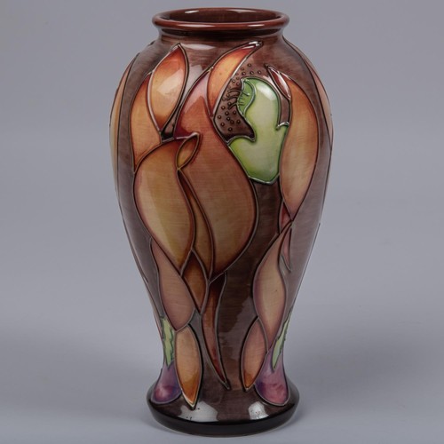 53 - A Moorcroft pottery vase. Leaf shapes in shades of brown on a graded ground. Marks to base, SP, flag... 