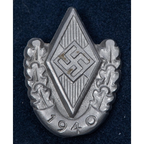 135 - Five Third Reich small pin back badges: NSKOV membership badge, by 