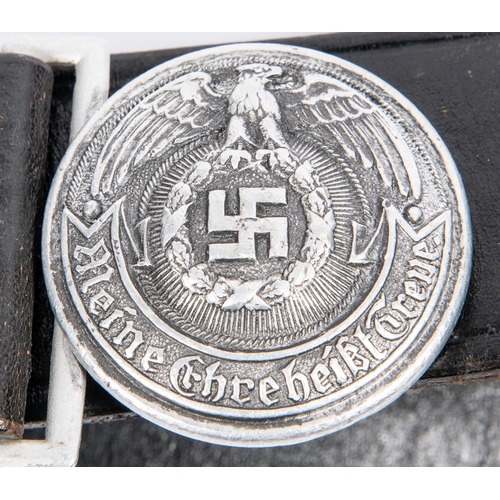 142 - A Third Reich SS leaders circular aluminium buckle, 45mm diameter, the back bearing RZM mark, SS in ... 