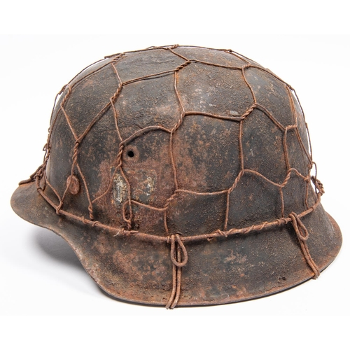 163 - A Third Reich M1943 raw edge steel helmet, in combat condition with traces of 