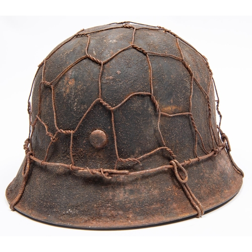 163 - A Third Reich M1943 raw edge steel helmet, in combat condition with traces of 