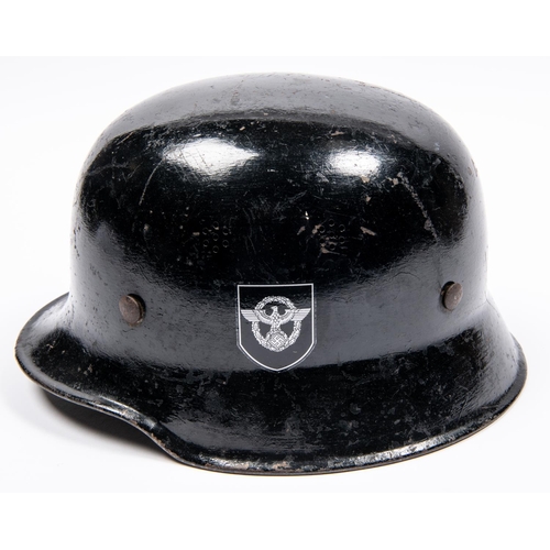 165 - A Third Reich steel police helmet, painted black with replacement decals, lining and chinstrap. GC £... 