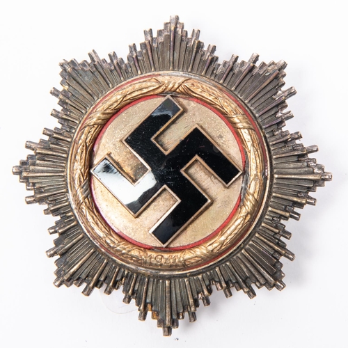 91 - A WWII German Cross (Deutsches Kreuz) in gold, the concave back having four domed rivets, maker's st... 