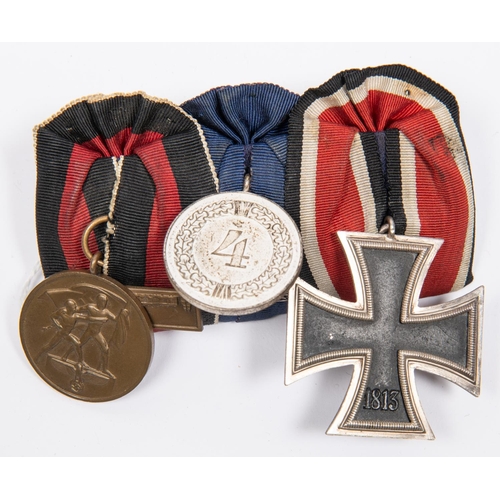 94 - A German Third Reich medal trio: 1939 Iron Cross 2nd class, 4 year Long Service medal, and medal for... 