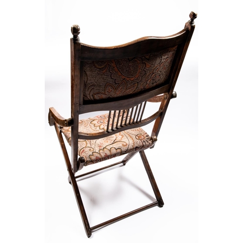 217 - A Victorian mahogany folding campaign chair, with studded and tapestry embroidered head panel, simil... 