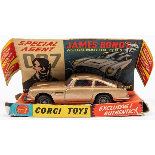 340 - 2 Corgi Toys. A James Bond Aston Martin DB5 (261). Gold body, red interior and 'wire wheels'. no ban... 