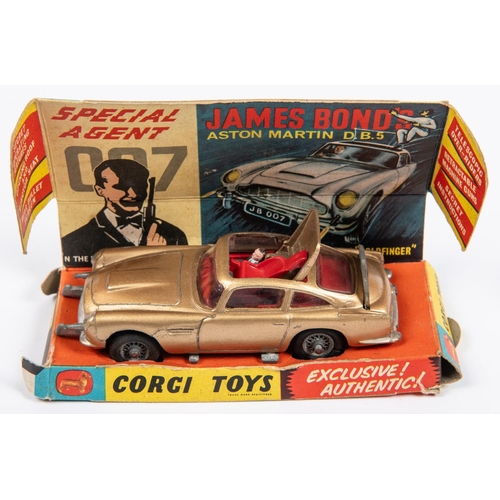 340 - 2 Corgi Toys. A James Bond Aston Martin DB5 (261). Gold body, red interior and 'wire wheels'. no ban... 