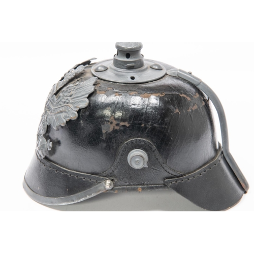 152 - A WWII Prussian pickelhaube, with grey painted brass badge (sceptre missing) and steel mounts. Worn ... 