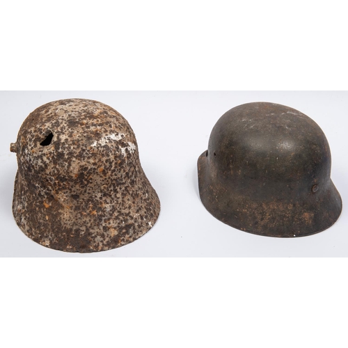 153 - A Third Reich M1935 steel helmet, traces of decal on left side, QGC (quite pitted); a Model 1916 WWI... 