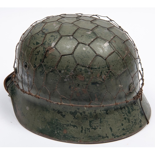 154 - A Third Reich double decal M40 steel helmet, with state shield and army eagle, leather liner with th... 