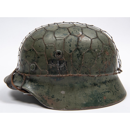 154 - A Third Reich double decal M40 steel helmet, with state shield and army eagle, leather liner with th... 