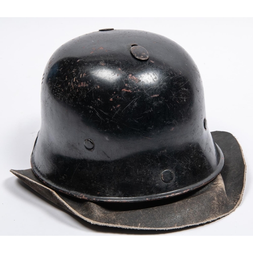 157 - A late WWII or post war German Fire Service helmet, similar to M1935 helmet with leather neck curtai... 