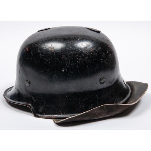 157 - A late WWII or post war German Fire Service helmet, similar to M1935 helmet with leather neck curtai... 