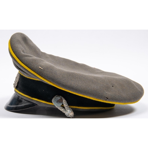 161 - A well made copy of a Third Reich cavalry officer's peaked cap, grey with yellow piping, alloy badge... 