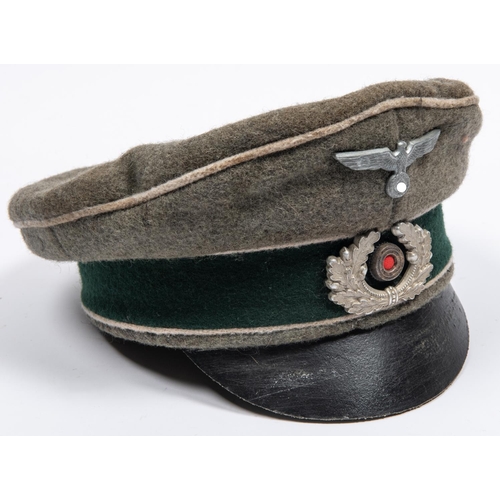 162 - A well made copy of a Third Reich infantry officer's peaked cap, field grey with alloy badges. GC £2... 