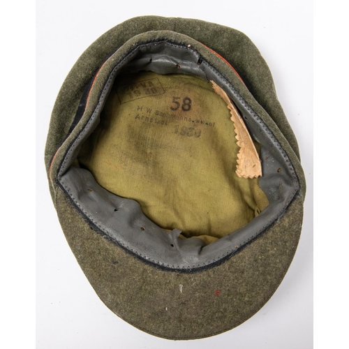 163 - A good quality copy of a Third Reich Waffen SS peaked cap, field grey with alloy badges. GC £300-350