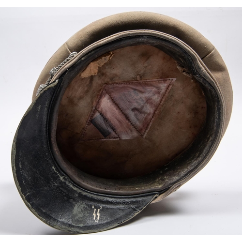 164 - A Third Reich SS officer's tropical peaked cap, white drill body, alloy eagle and skull badges, brai... 