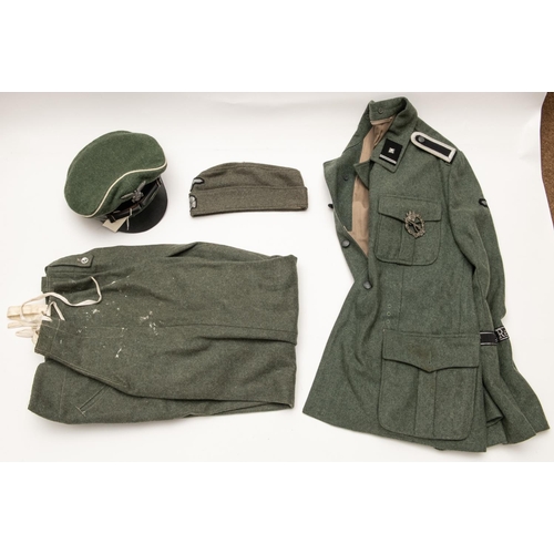 175 - A good quality copy of a Waffen SS mans uniform, comprising: field cap, tunic with Das Reich insigni... 