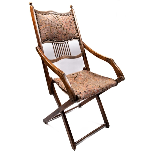 217 - A Victorian mahogany folding campaign chair, with studded and tapestry embroidered head panel, simil... 