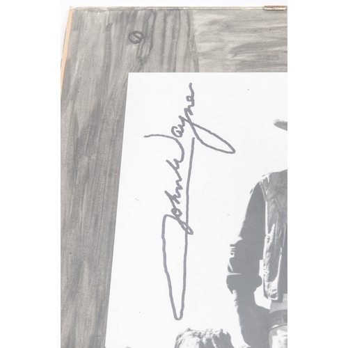 30 - An autographed photograph of John Wayne, 10