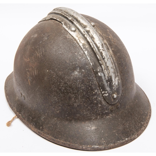 314 - A WWII French Adrian helmet, with RF badge and leather chinstrap. GC (leather lining missing) £40-50