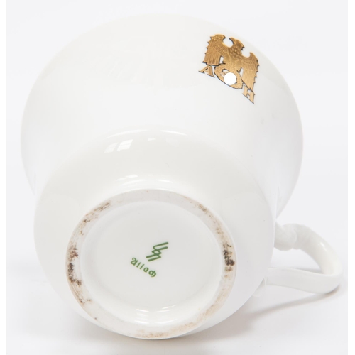 91 - A Third Reich china cup and saucer with gilt eagle and swastika flanked by 