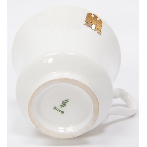 92 - A Third Reich china cup and saucer with gilt eagle and swastika flanked by 