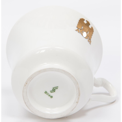 93 - A Third Reich china cup and saucer with gilt eagle and swastika flanked by 