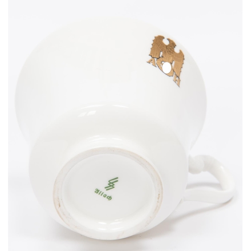 94 - A Third Reich china cup and saucer with gilt eagle and swastika flanked by 