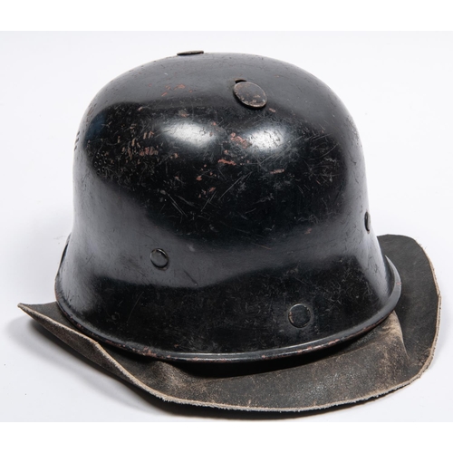 160 - A late WWII or post war German Fire Service helmet, similar to M1935 helmet with leather neck curtai... 