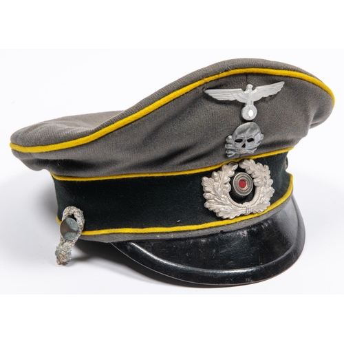169 - A well made copy of a Third Reich cavalry officer's peaked cap, grey with yellow piping, alloy badge... 