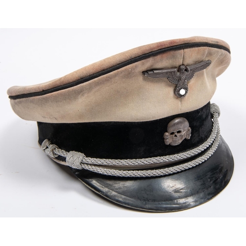 164 - A Third Reich SS officer's tropical peaked cap, white drill body, alloy eagle and skull badges, brai... 