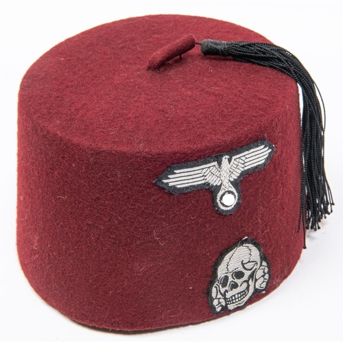 175 - An officer's fez, lining marked with crescent and stars, modern replica SS badges affixed. GC £40-60