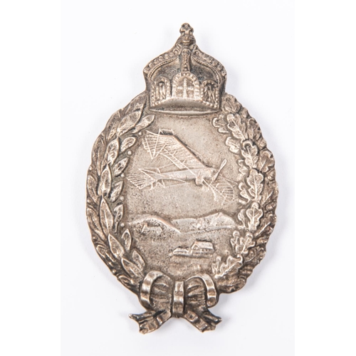 113 - An old cast copy of a WWI German Pilot's badge, of heavy white metal construction with integral hing... 