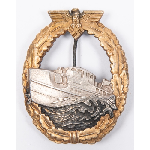 122 - A Third Reich first pattern E Boat War badge, of heavy white metal construction, with silver boat on... 