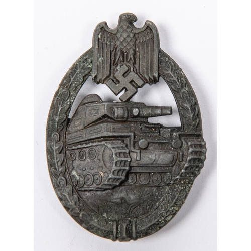 126 - A Third Reich Panzer Assault badge, of grey metal with slightly concave back, partly fretted out swa... 