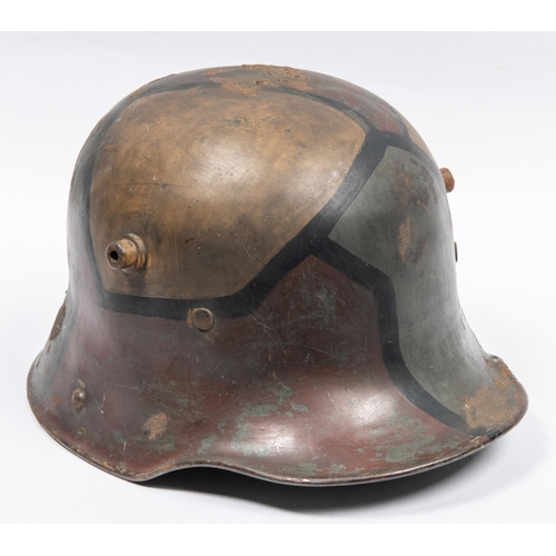 153 - An Imperial German M1916 steel helmet, with original geometric camouflage paint finish, leather lini... 