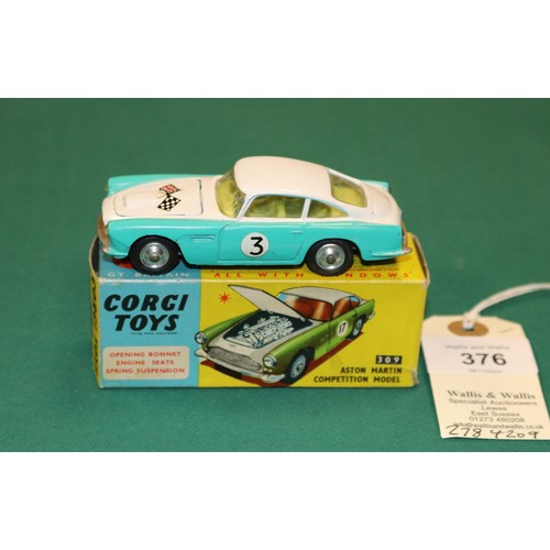 376 - Corgi Toys Aston Martin Competition Model (309). In white and turquoise, with crossed flags to bonne... 